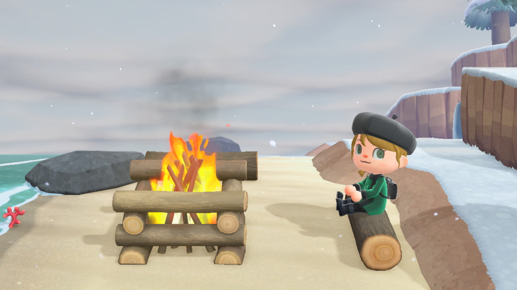Millicent sitting by a bonfire as snow begins to fall on Lunamori.